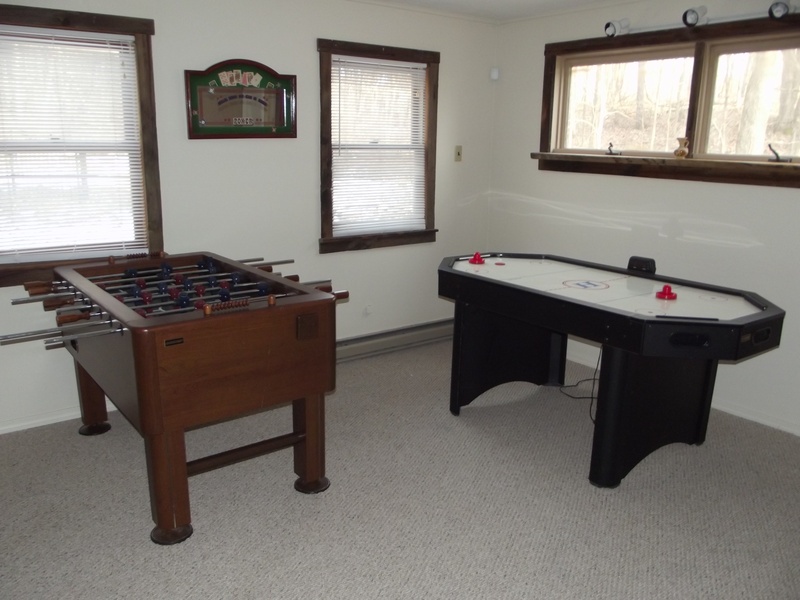 A room with a foosball table and a foosball table.