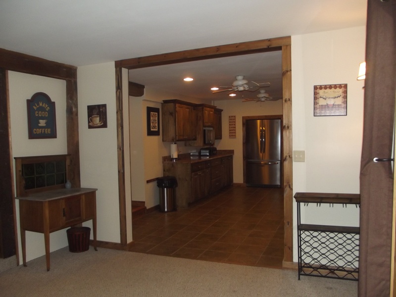 A hallway leading to a kitchen and dining room.