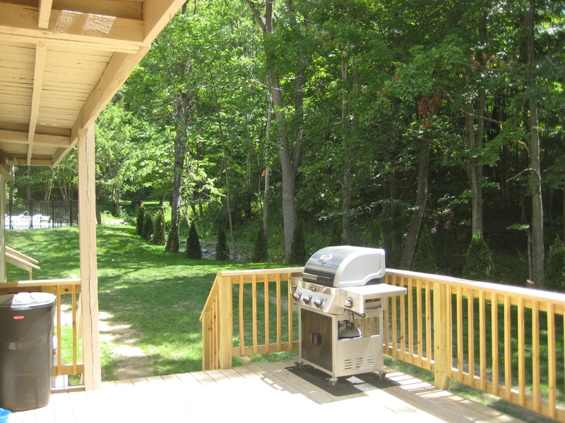 A deck with a grill on it.
