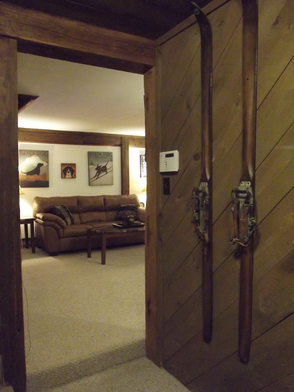A wooden door with skis hanging on it.