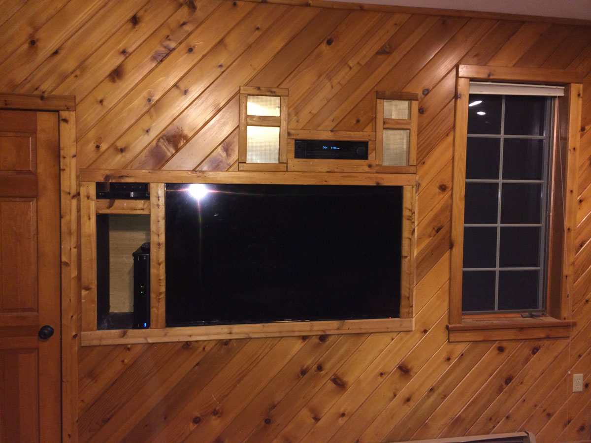 A living room with a tv mounted on the wall.