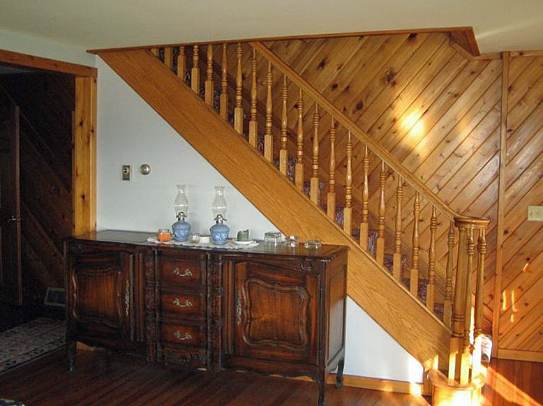 A wooden staircase in a living room.