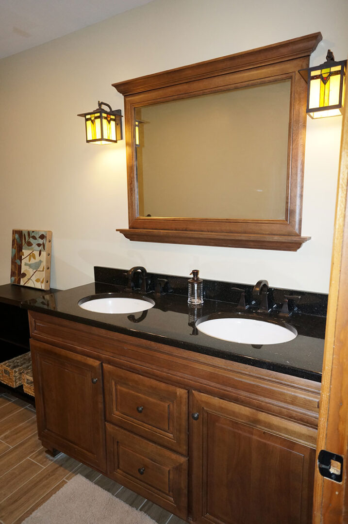 A bathroom with two sinks and a mirror.