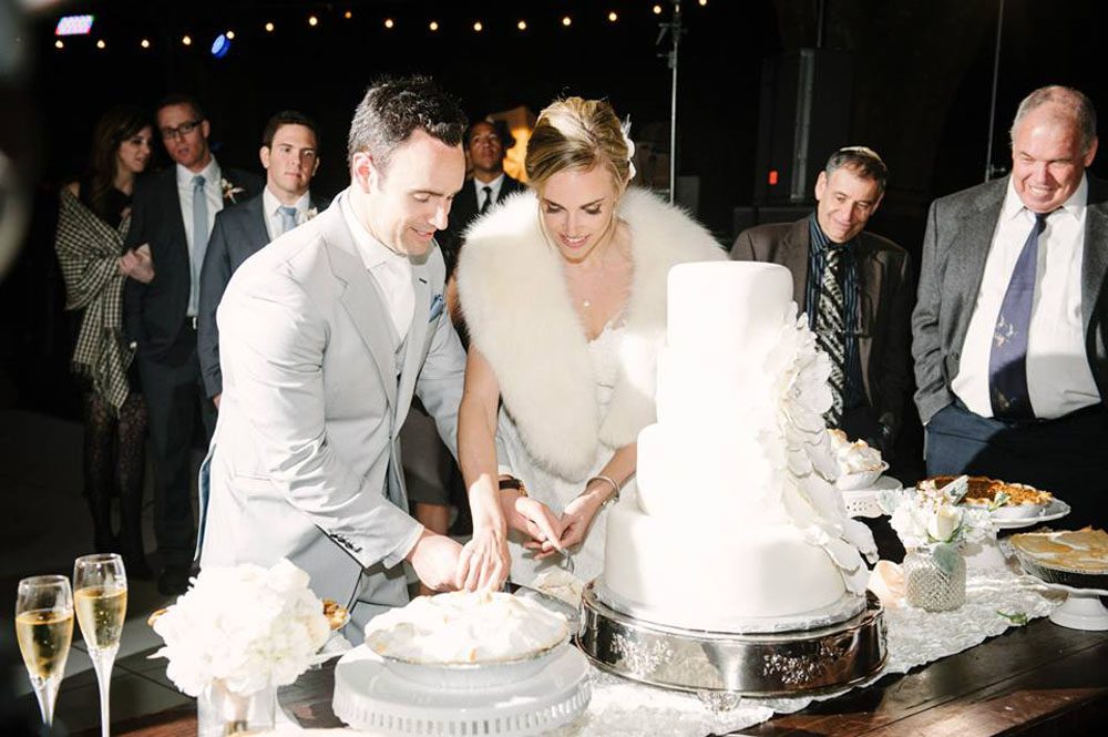 A bride and groom cutting a wedding cake.