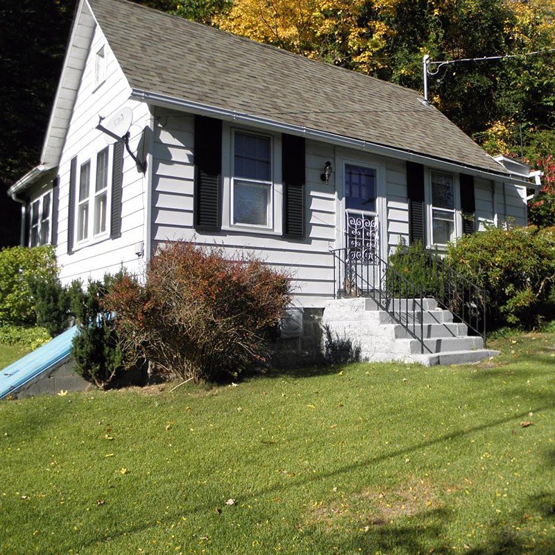 A house with a slide in front of it.