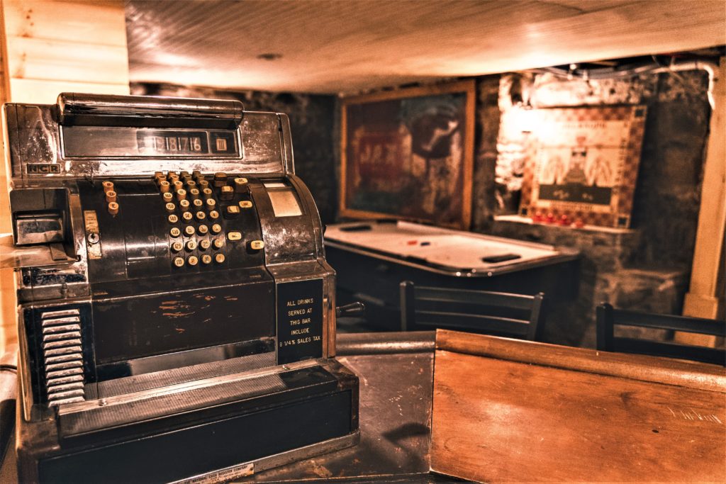 An old cash register in a bar.