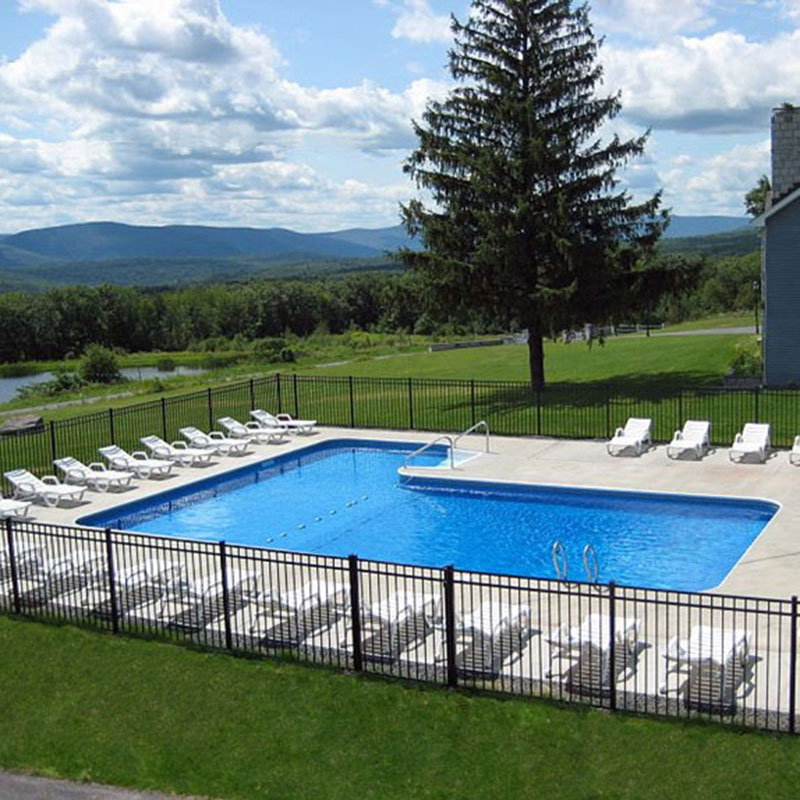 A fenced swimming pool on a grassy area