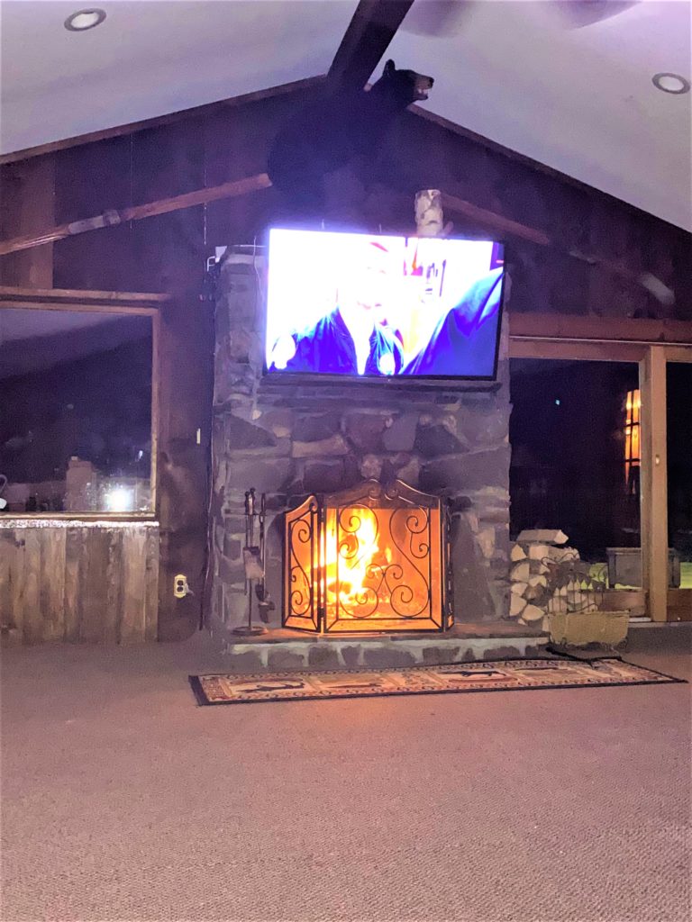 A fireplace with a tv above it.