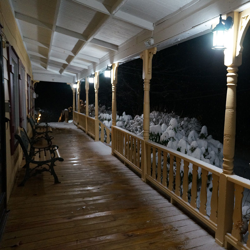 The porch is covered in snow.