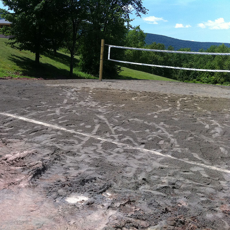 A beach volleyball court with black sand