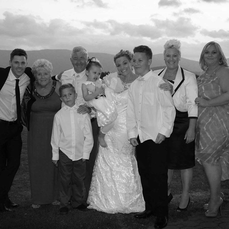 Black and white image of a family standing with the bride
