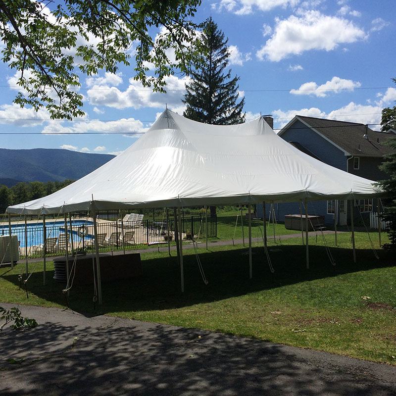 Outside view of a field with a tent placed in it for wedding