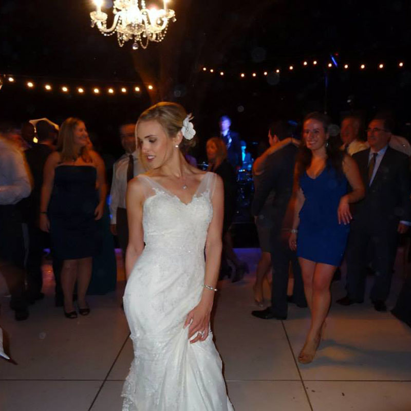 A bride dancing at the dance floor along with her friends