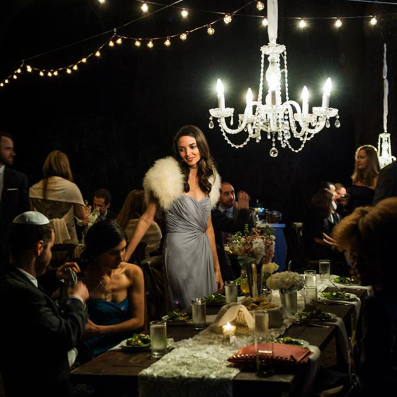 A bride standing at the party table in front of with other people