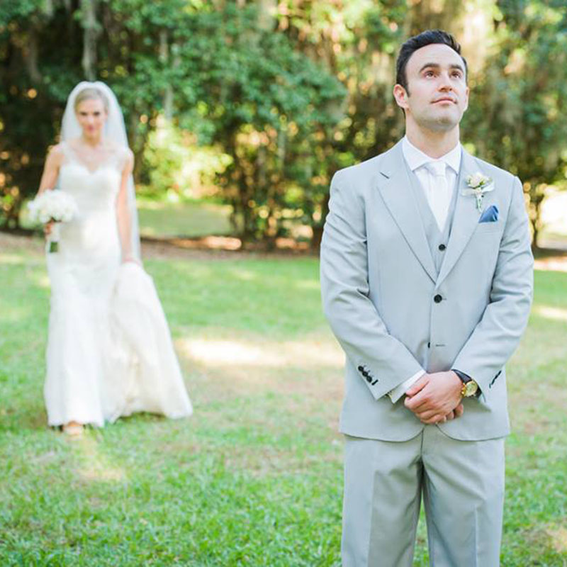 A bride and a groom standing together in an open field