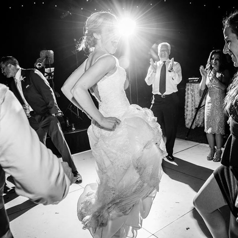 Black and white image of a girl dancing at a weeding