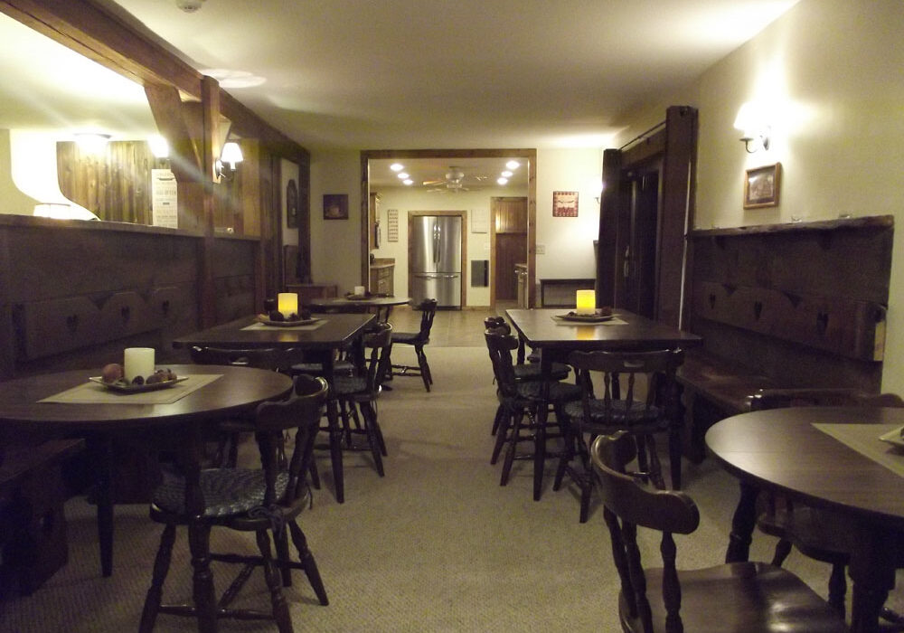 A dining room with tables and chairs.